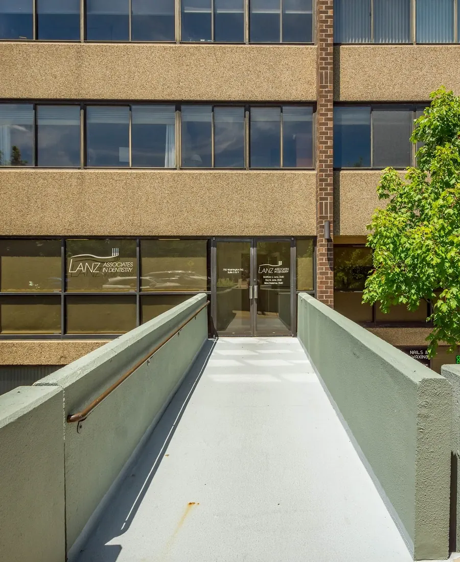 The entrance walkway to the Lanz Associates in Dentistry office at 750 Washington Road, with the Lanz logo on the glass doors.