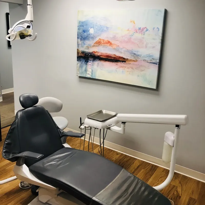 A dental chair beneath a colourful painting in a Mt. Lebanon treatment room.