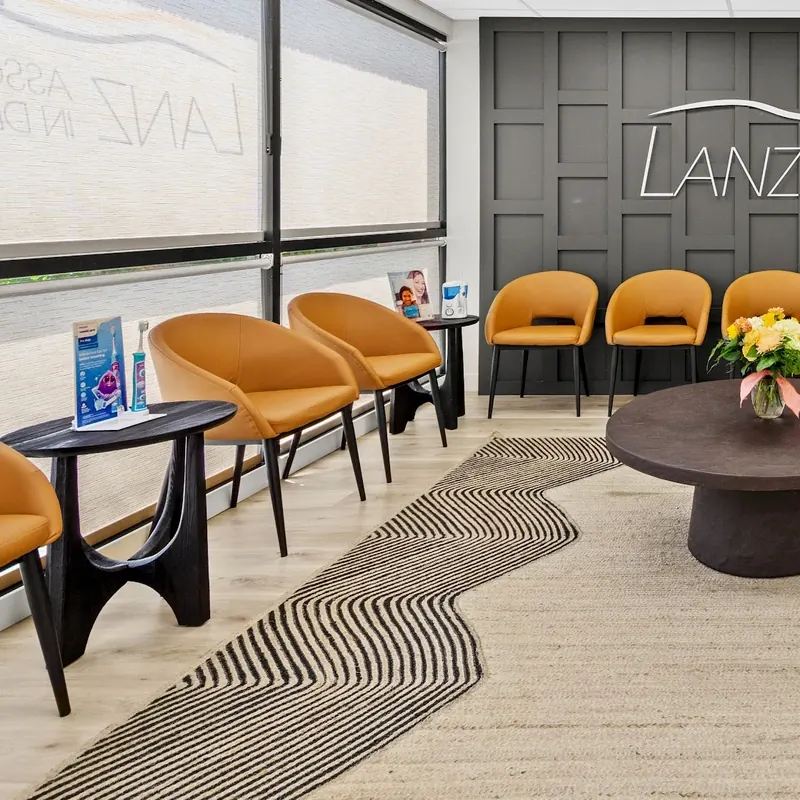 Orange chairs around a round table in the Mt. Lebanon waiting room.